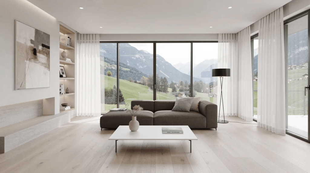 Un salon contemporain et minimaliste dans une villa en Suisse, avec des murs blancs et un sol en marbre. Le mobilier, incluant un canapé design, est disposé de manière à créer un espace accueillant, agrémenté de quelques accessoires décoratifs modernes.